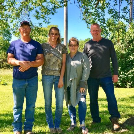 Raelynn and her husband with Mineo Jr. and Animal Health Specialist Michelle L.
