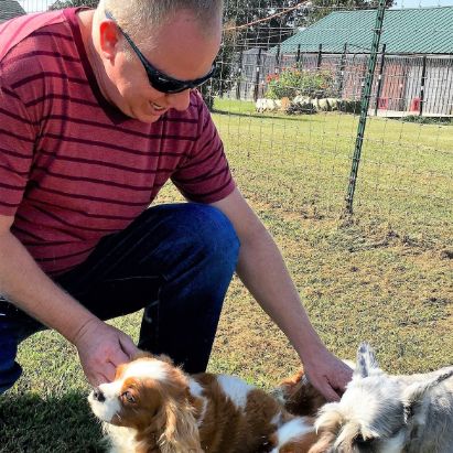 Frank Mineo Jr. playing with Stacy\'s dogs on 2016 breeder trip