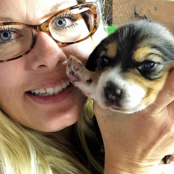 Animal Health Director Michelle L. holding puppy