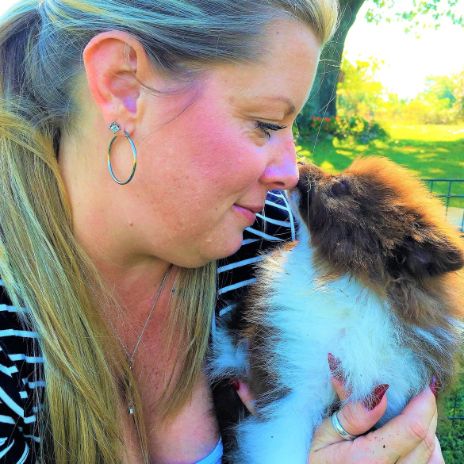 Puppies 'N Love & Animal Kingdom Animal Health Director Michelle L. holding Pomeranian dog