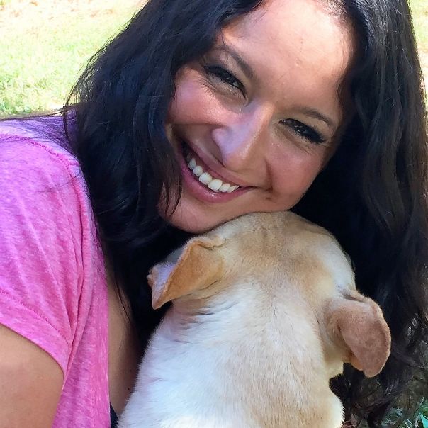 Puppies 'N Love store manager Loni T. snuggles with one of Jim and Tammy\'s dogs