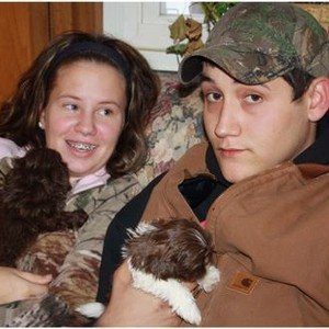 Arminta\'s children holding Shih Tzu puppies