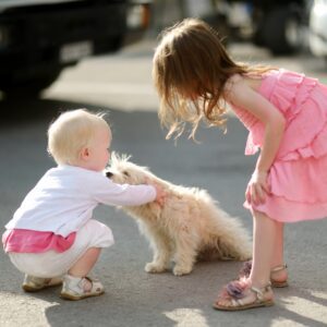 Two adorable girls met a puppy