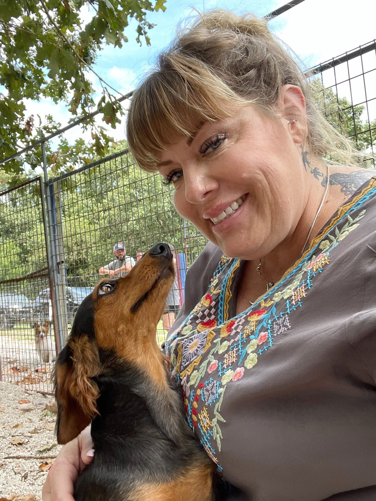 Our Animal Programs Director cuddling with a dachschund