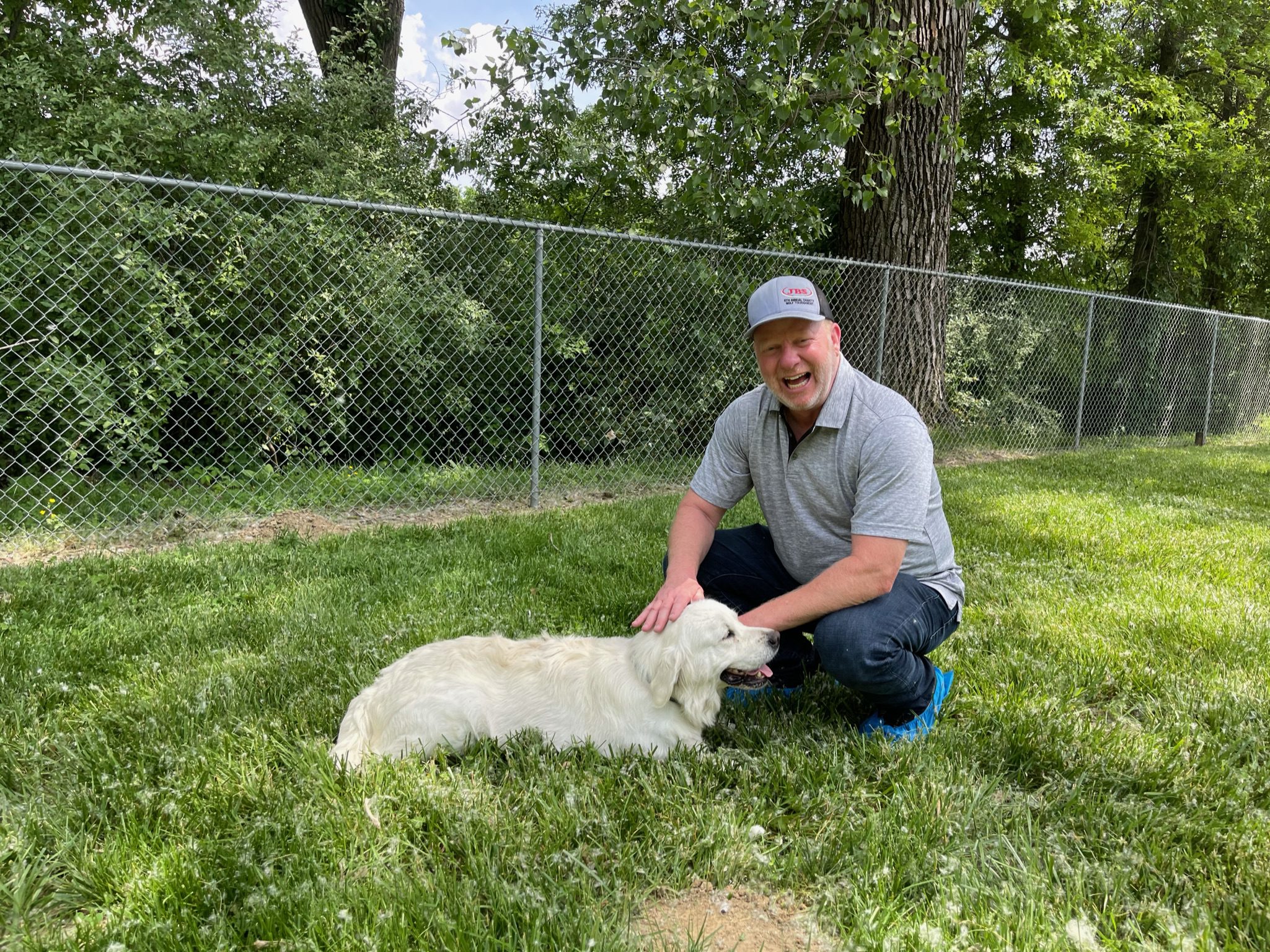 CEO and owner Frank Mineo petting one of Marcus\'s golden retrievers