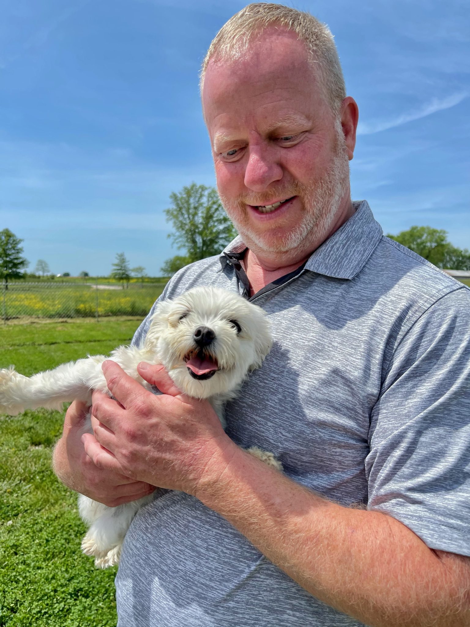 Owner of Puppies \'N Love/Animal Kingdom cuddling with an adult Maltese