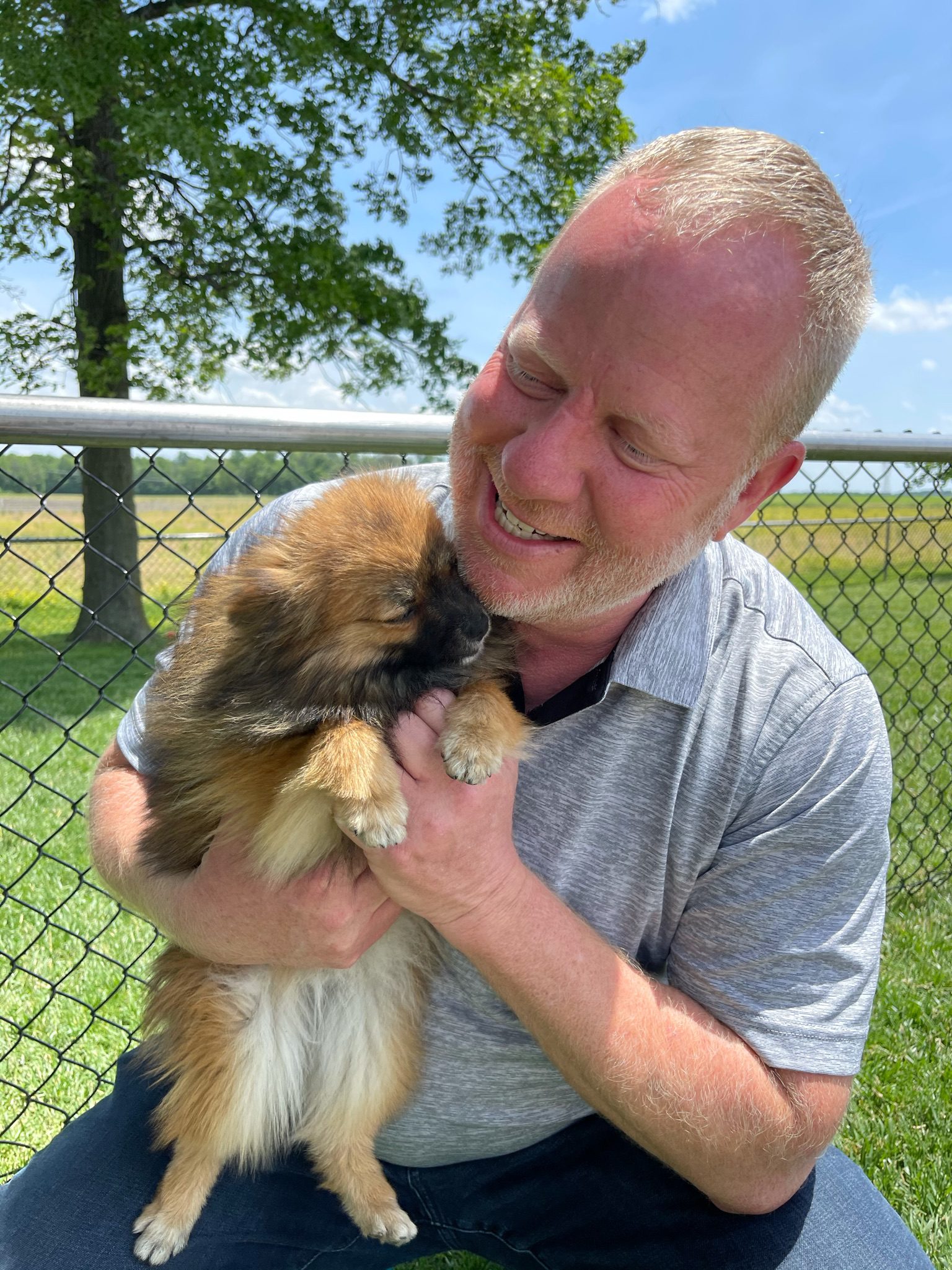 Owner of Puppies \'N Love and Animal Kingdom holding one of the adult Pomeranians