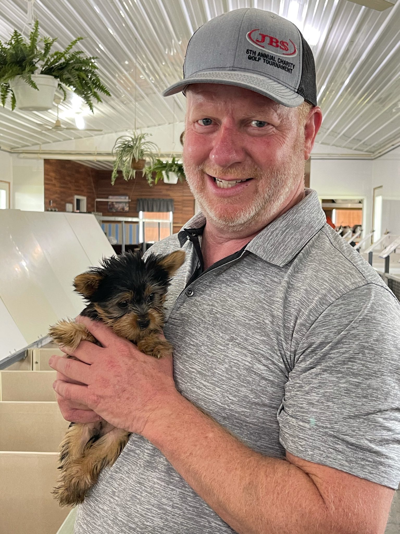 CEO and owner Frank Mineo cuddling a Yorkshire Terrier puppy