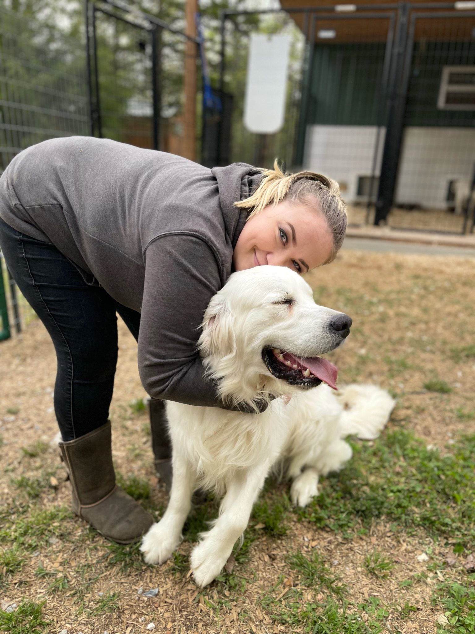 Manager of Breeder Support Roxette cuddling with a Golden Retriever