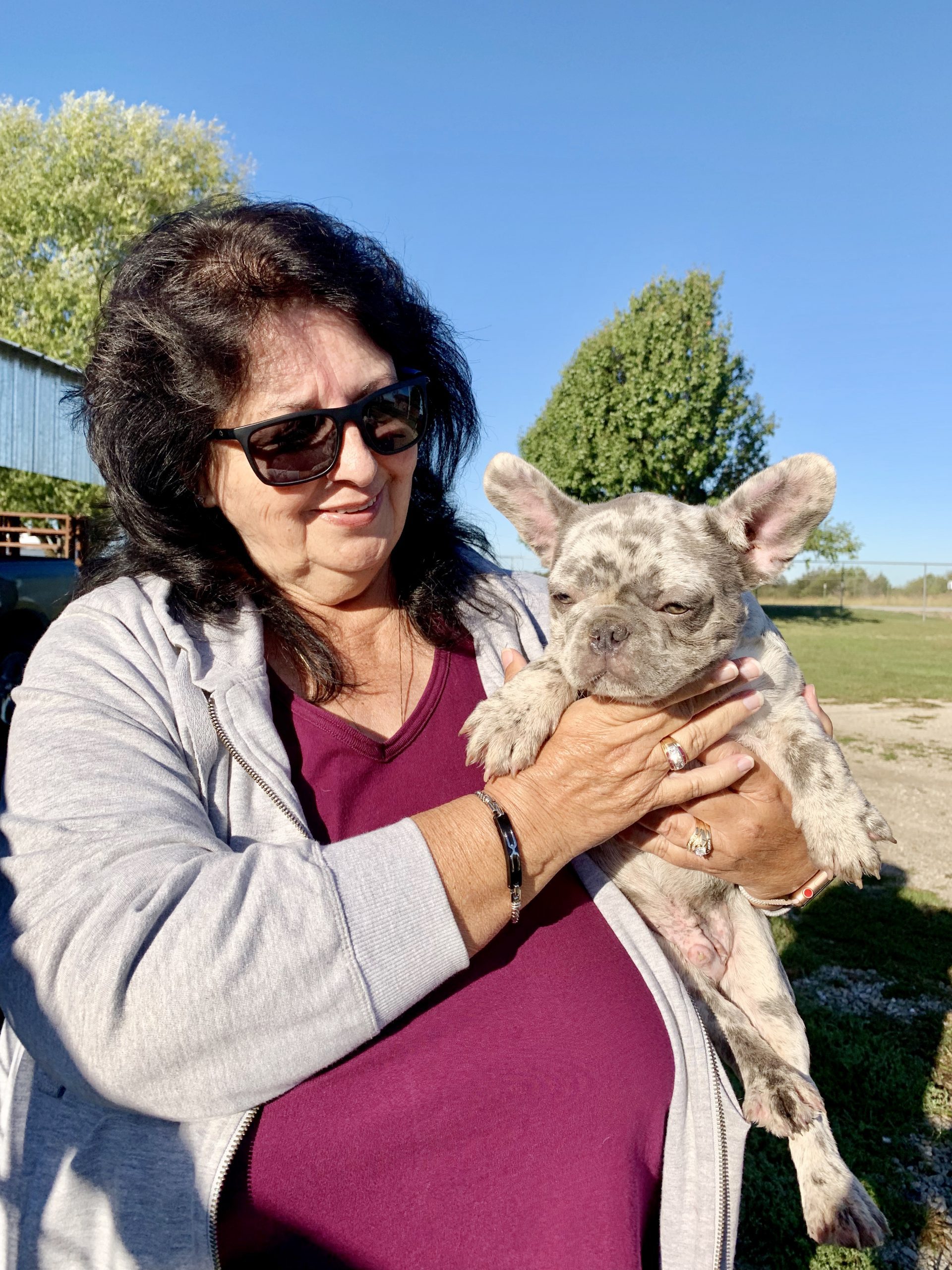 Kim's mom holding a French Bulldog adult