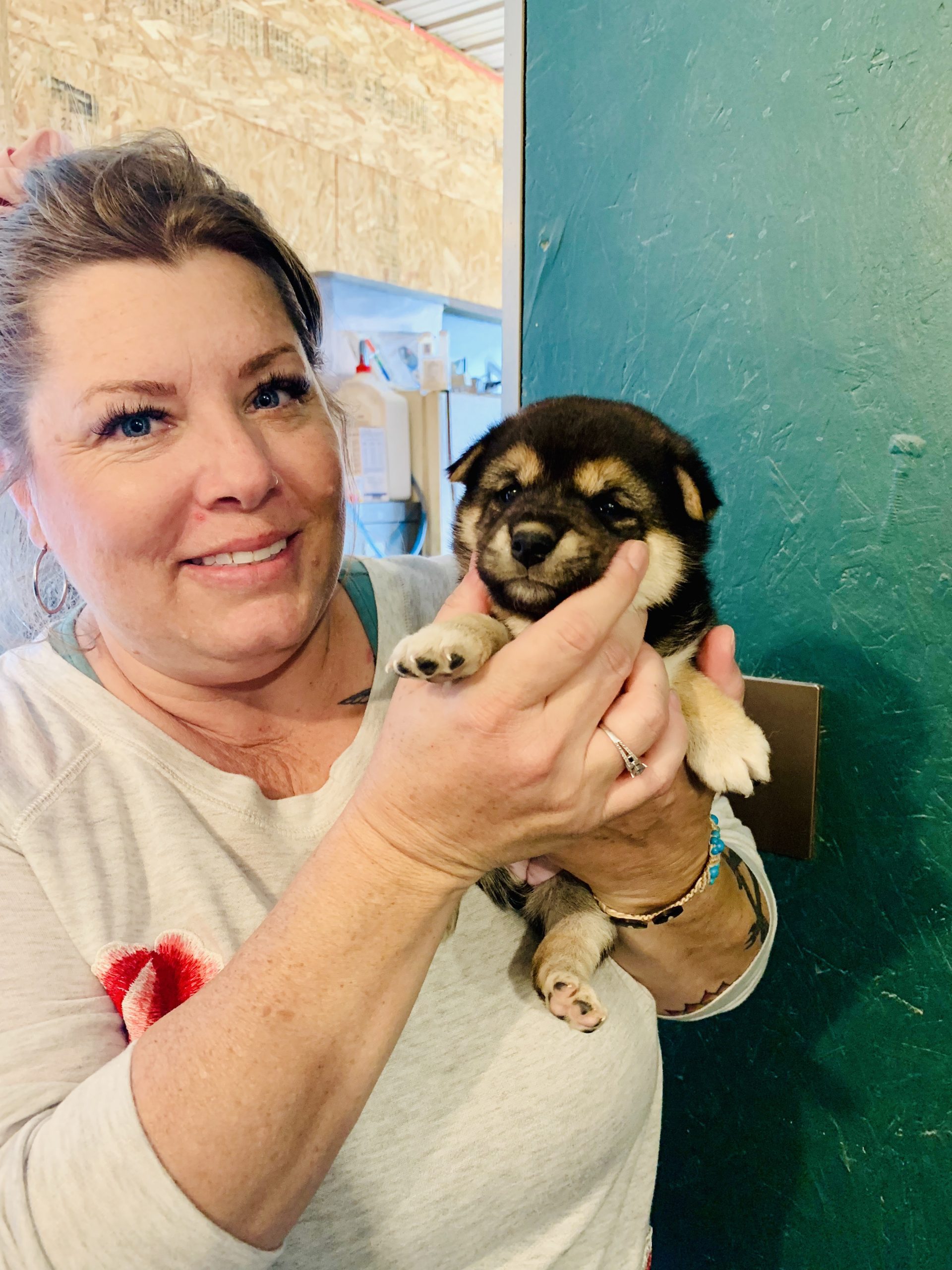 CPI employee holding one of Tim and Lisa's puppies