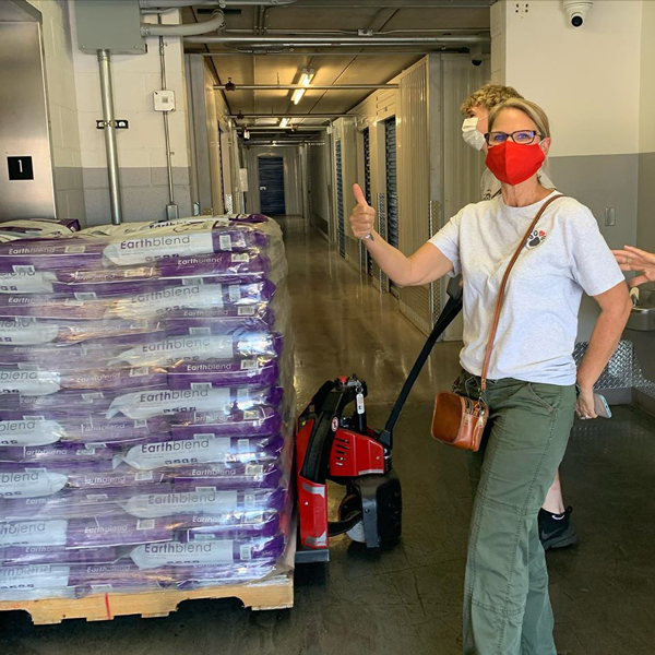 Lisa with the pallet of Earthblend Dog Food