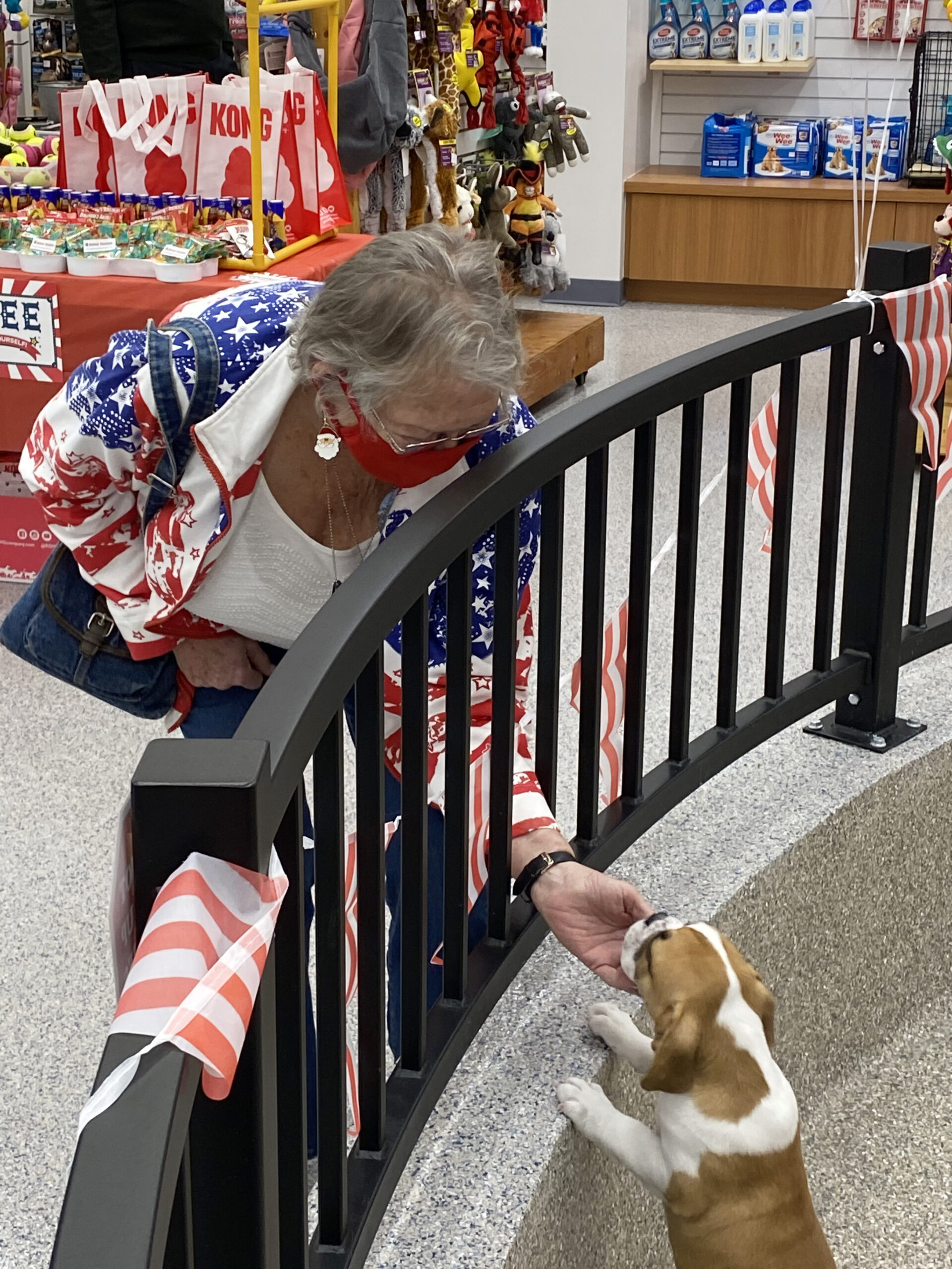 Sheron Jones greets a puppy at the store