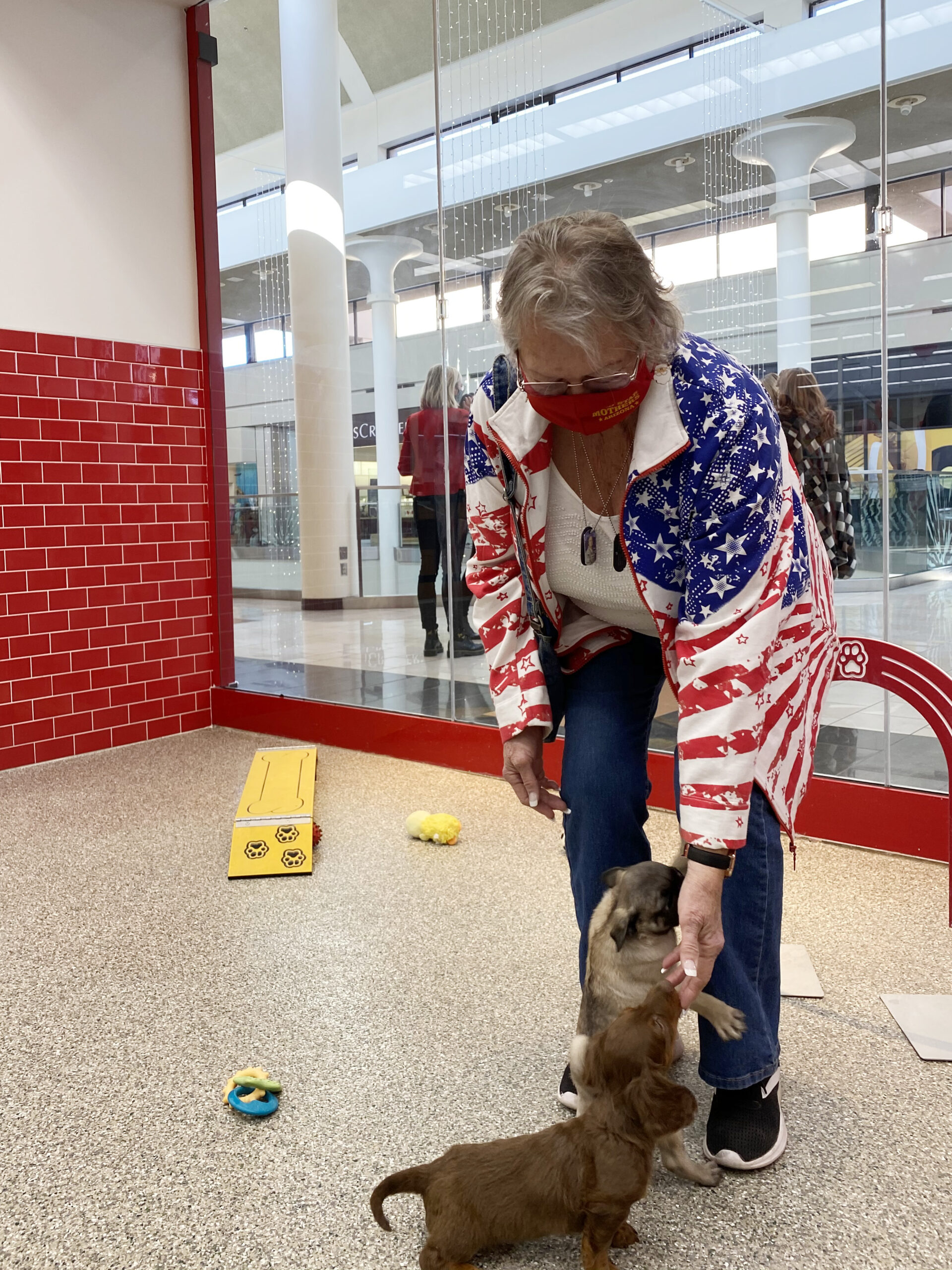 Sheron Jones playing with puppies at the store